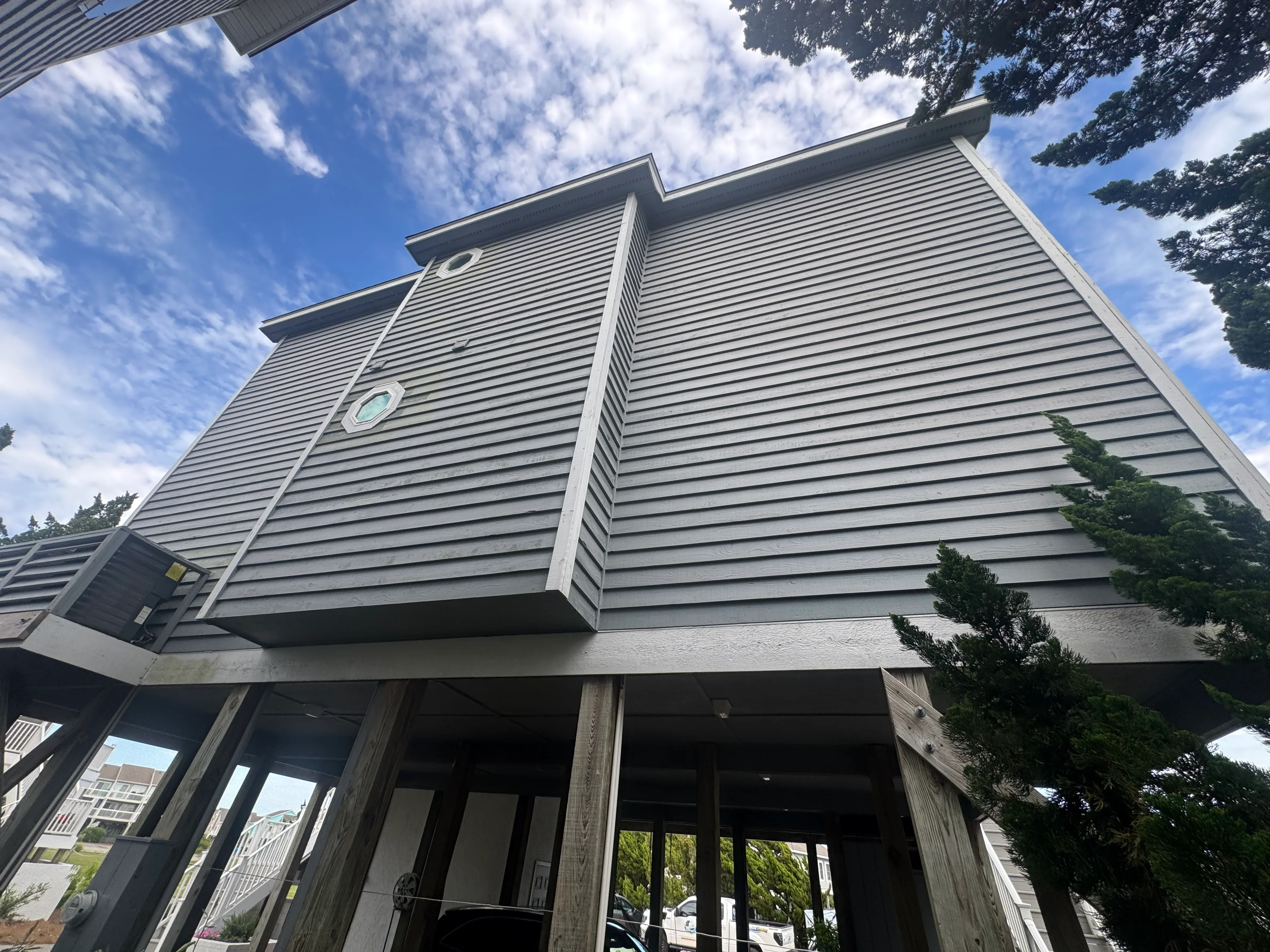 Light gray horizontal fiber cement siding with matching trim on two-story residential home