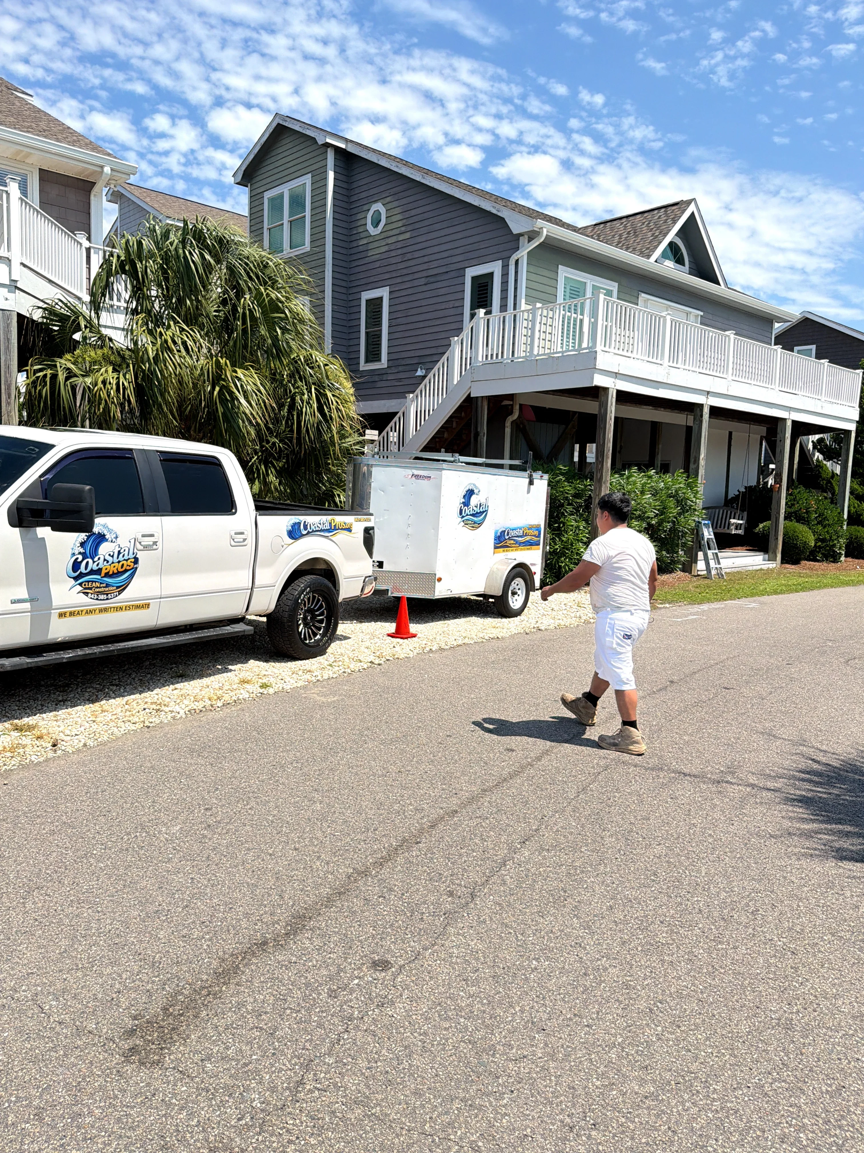Driveway pressure washing on asphalt surface at residential home