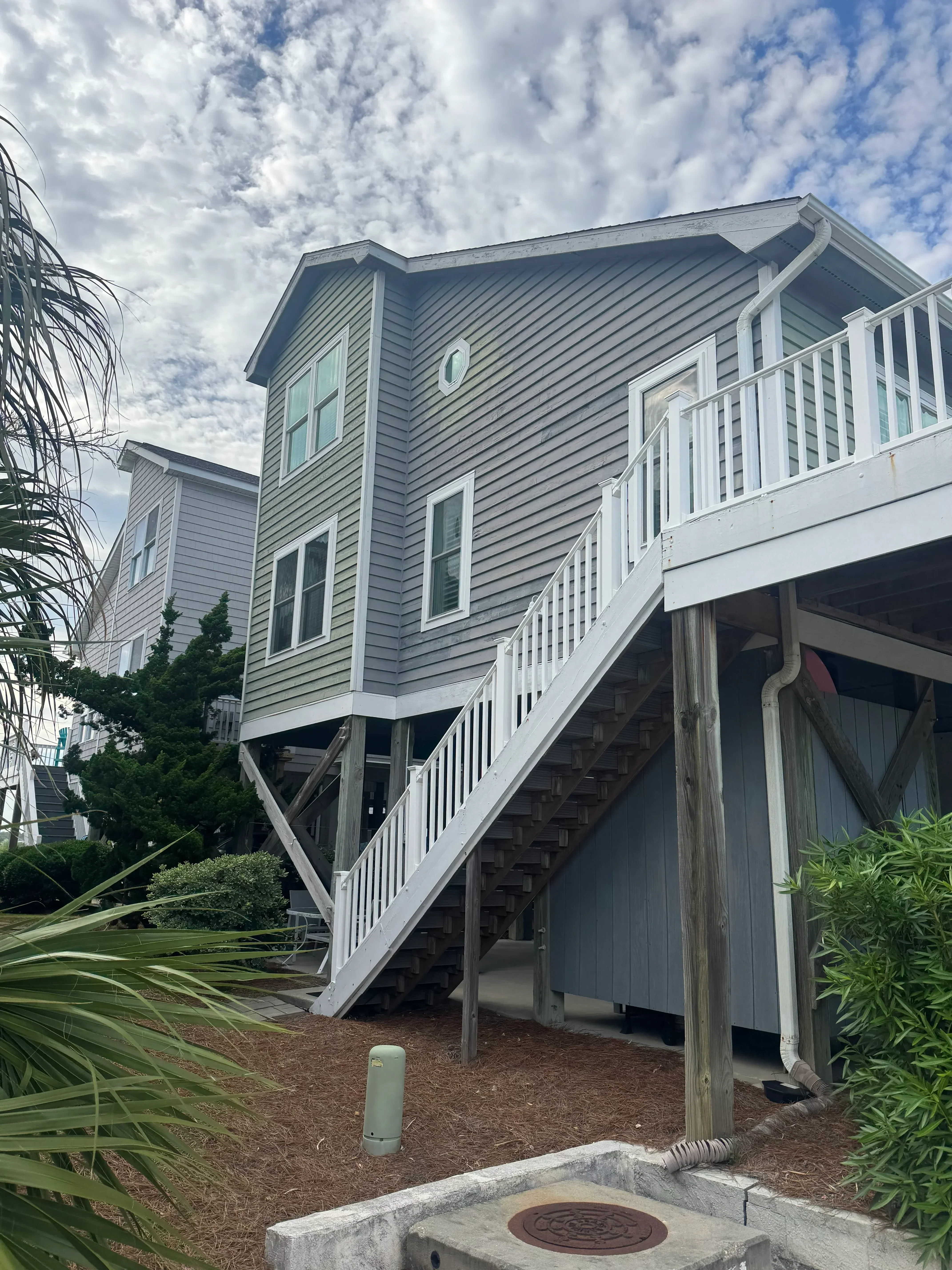 Gray standing seam metal roof with gutters, fascia, and soffit on residential structure